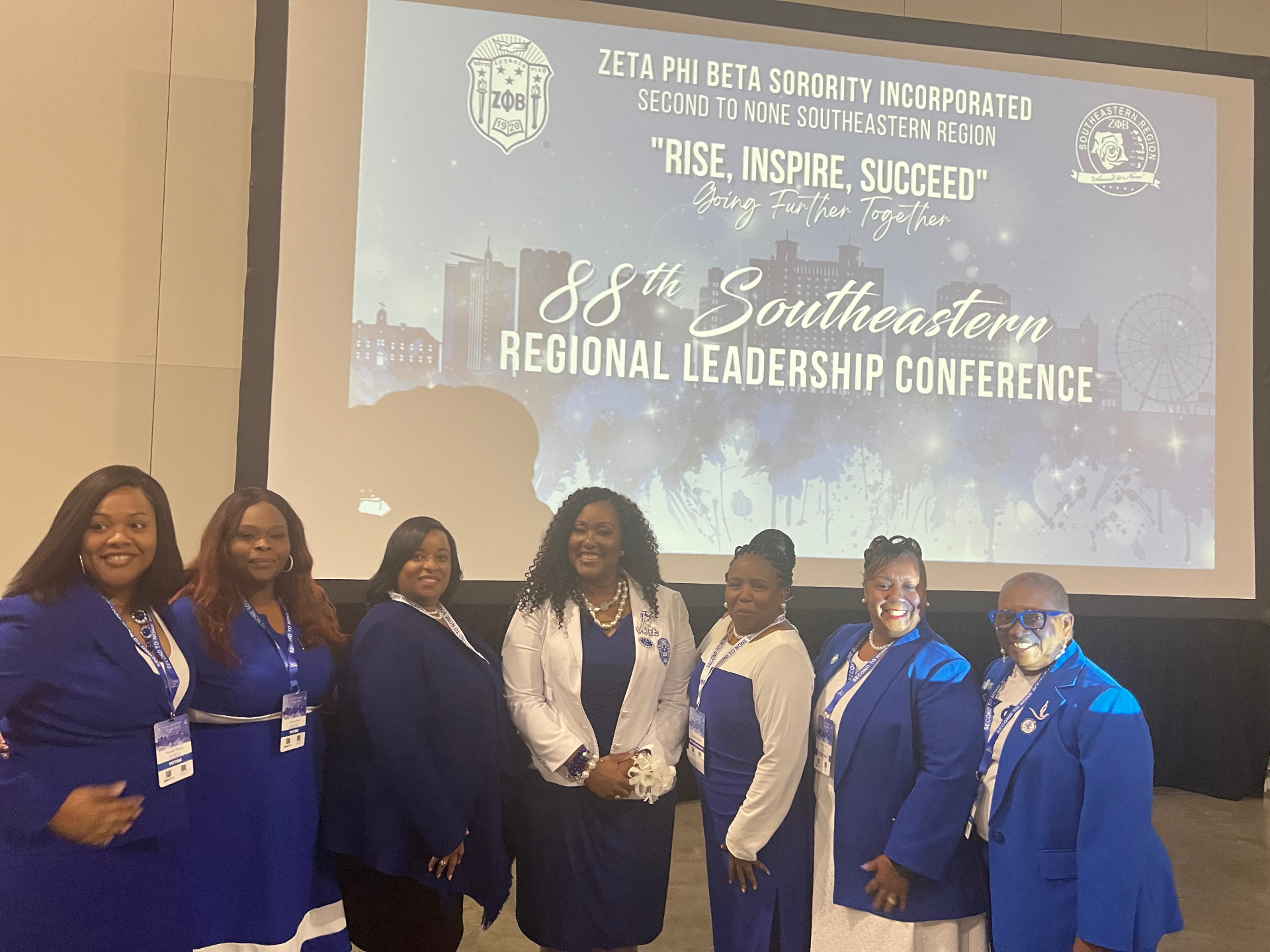 Latoya Jeeter with regional leaders in front of the Southeastern Regional Leadership Conference screen